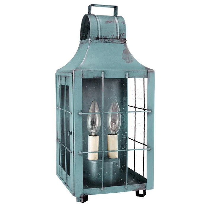 Vintage-style teal lantern with glass panels on a white background