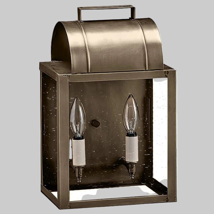 Bronze outdoor wall light fixture with two clear bulbs on a gray background