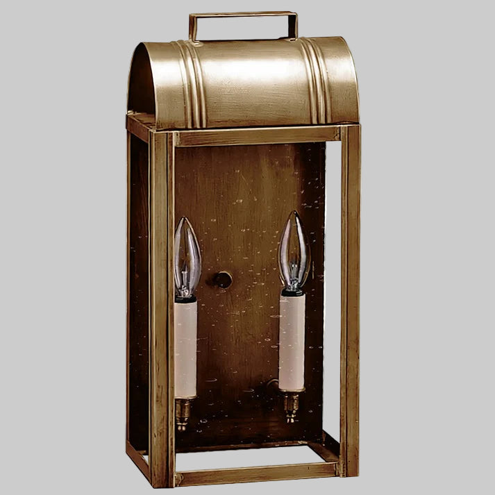 Bronze outdoor wall lantern with two candle-like lights on a gray background