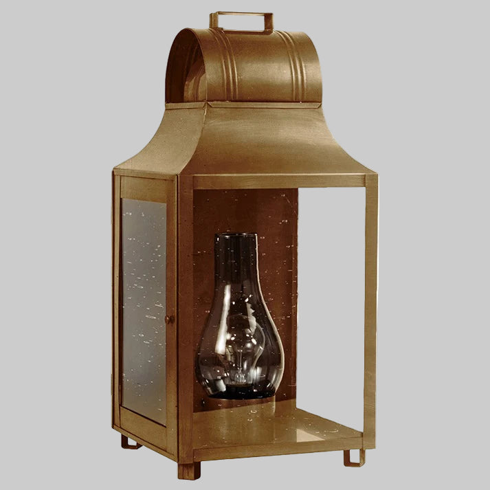 Bronze lantern with a glass insert on a white background