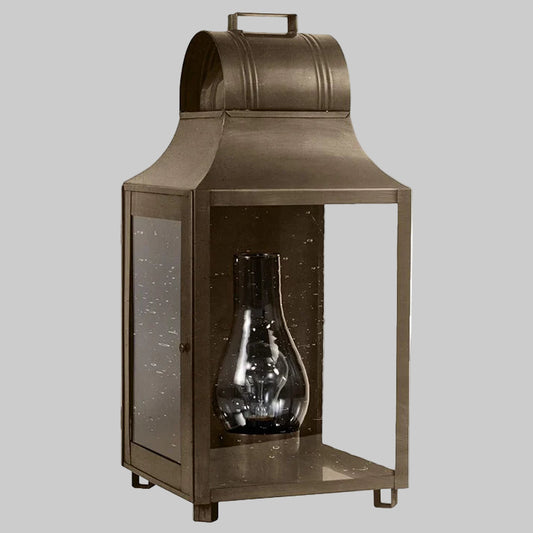 Bronze lantern with a clear glass shade on a white background