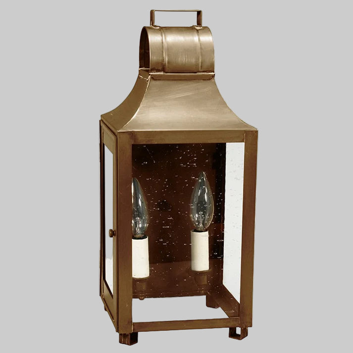 Bronze lantern with glass panels on a gray background