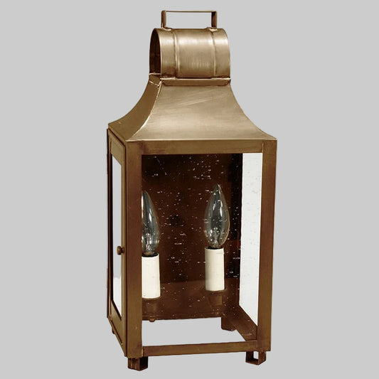Bronze lantern with glass panels on a gray background