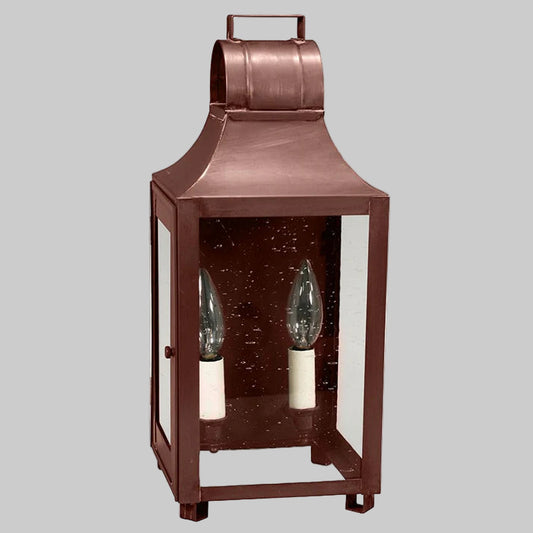 Bronze lantern with two candle lights on a gray background