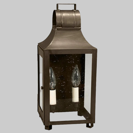 Bronze lantern with two candle holders on a gray background