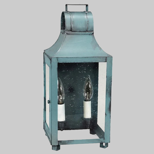 Blue lantern with two candle holders on a gray background