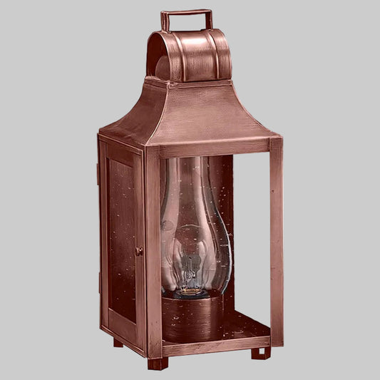 Bronze lantern with a clear glass cover on a gray background