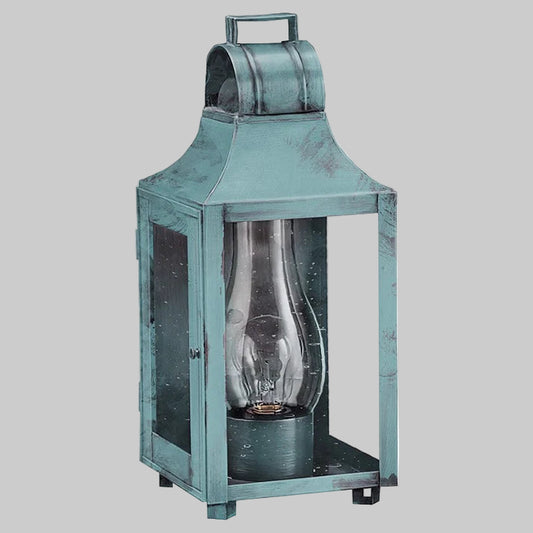 Vintage-style teal lantern with a clear glass cover on a gray background