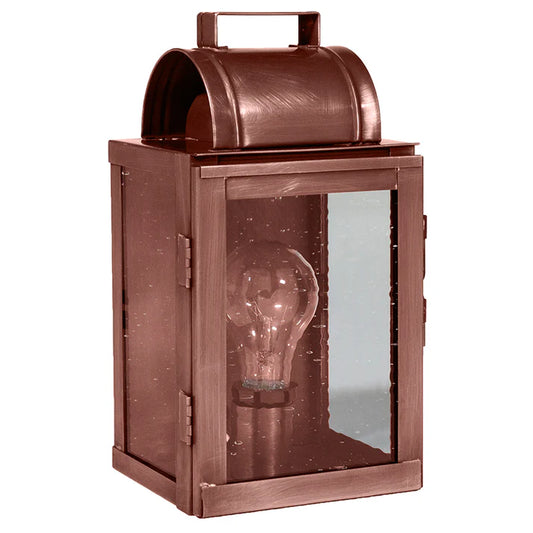 Copper lantern with a visible light bulb inside on a white background