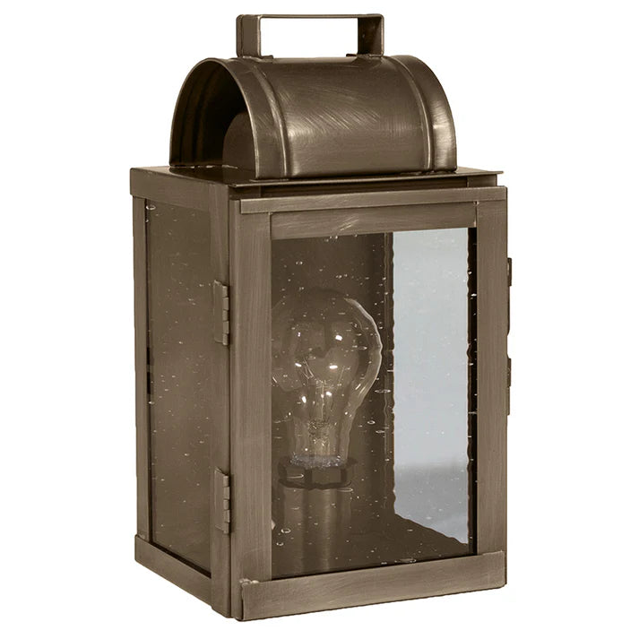 Bronze lantern with a visible light bulb inside on a white background