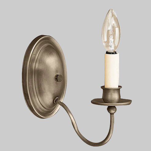 Wall-mounted light fixture with a single candle-style bulb on a gray background