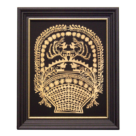 A framed paper cutting art of a basket with birds, designed with intricate scherenschnitte patterns, displayed in a black frame with gold trim.