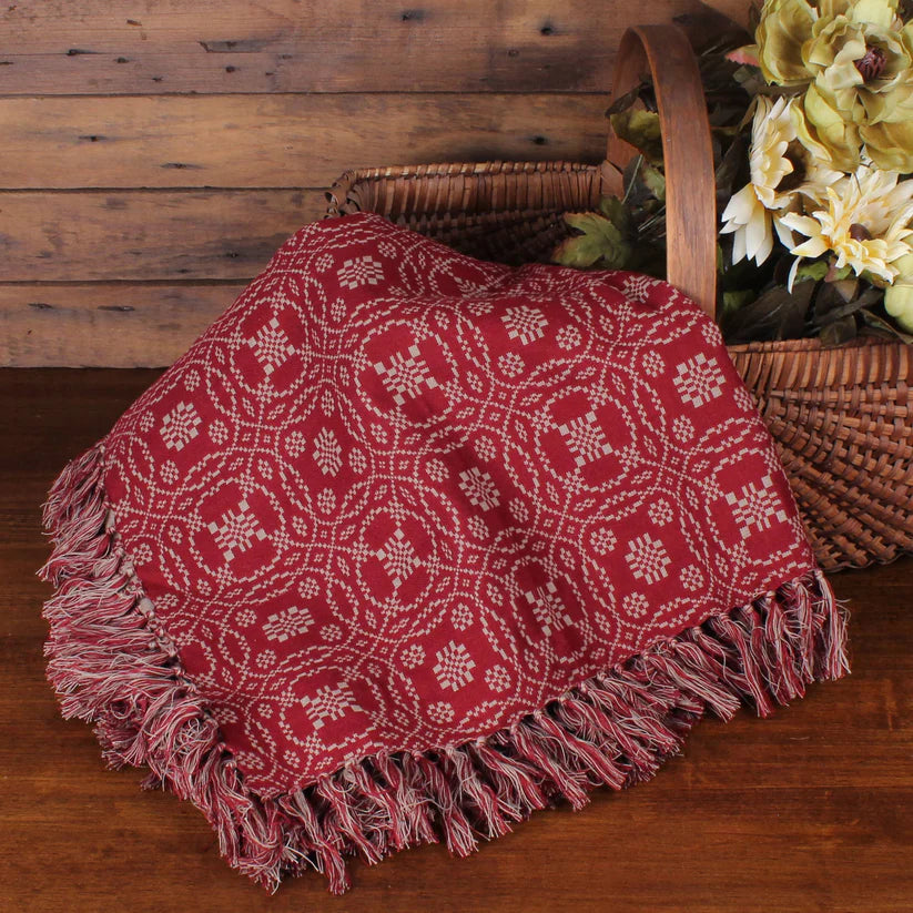 Lover's knot barn red throw next to primitive basket