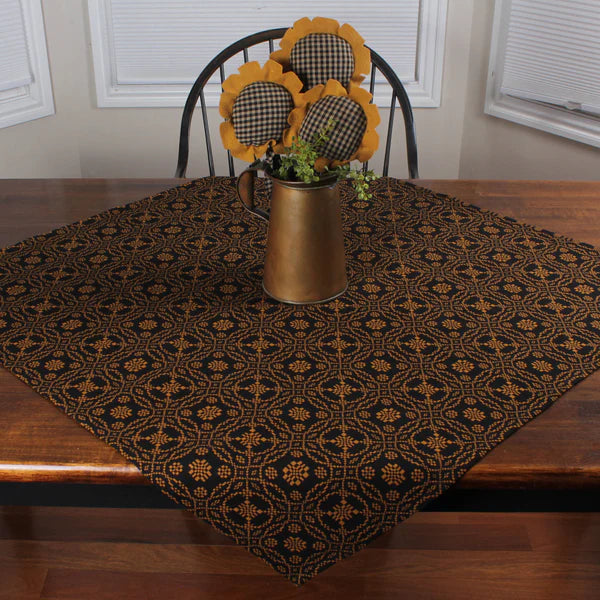 Lover's knot table square on wooden table with sunflowers in pitcher