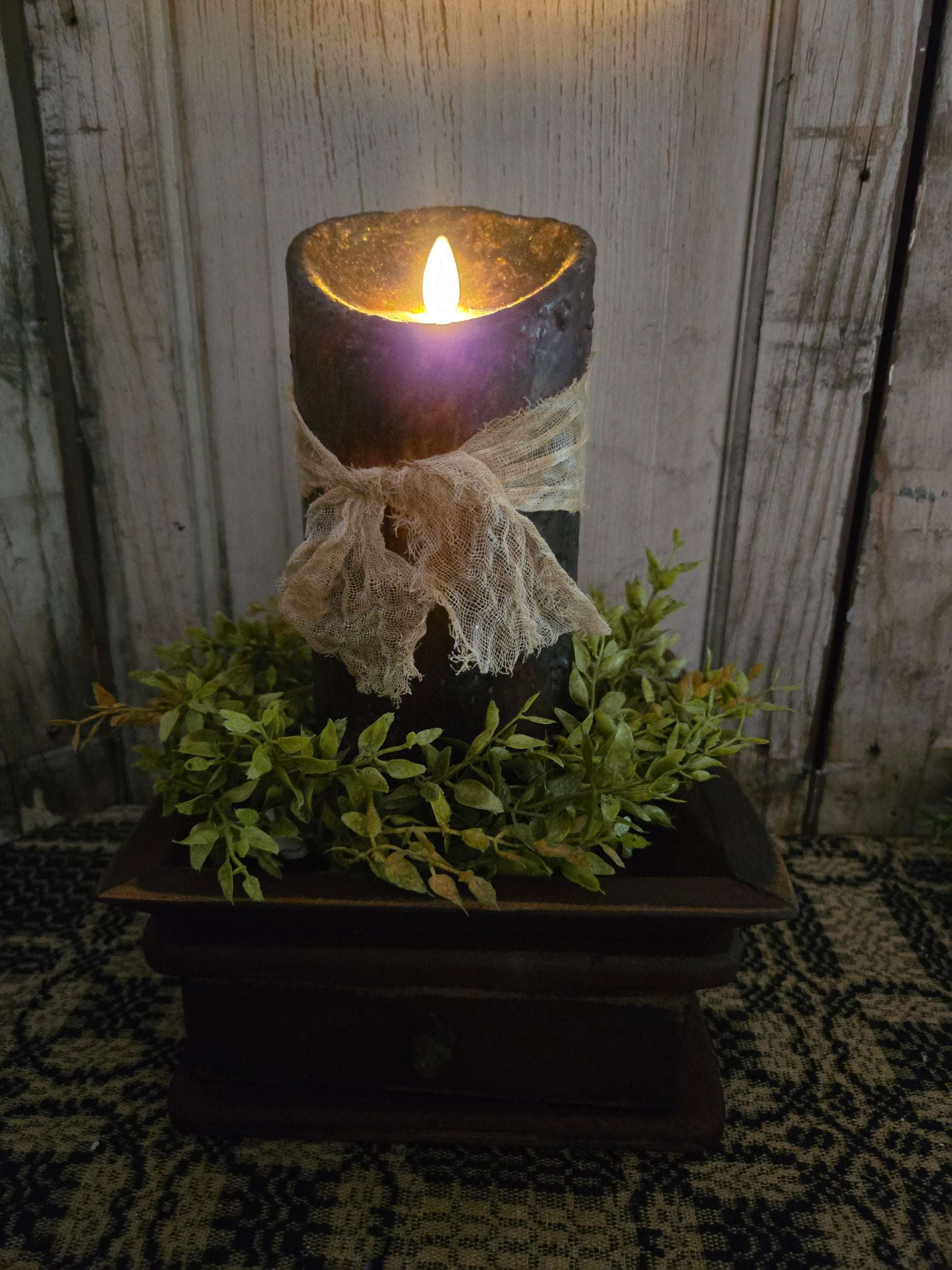 Luminara moving flame pillar candle in a dark setting