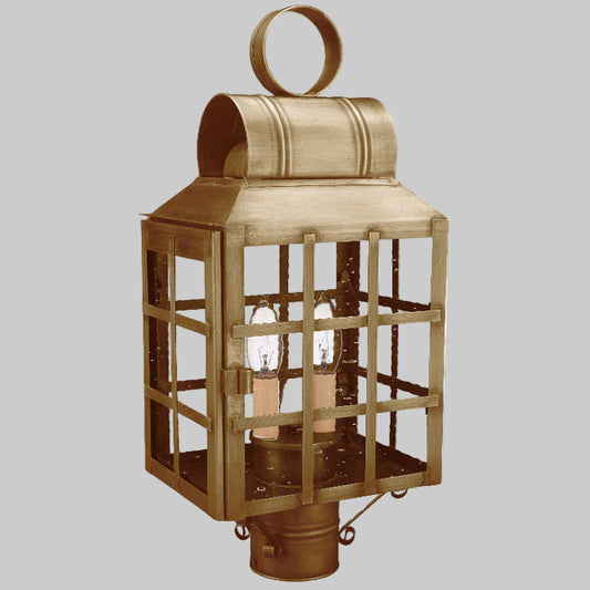 Bronze outdoor lantern with grid design on a gray background