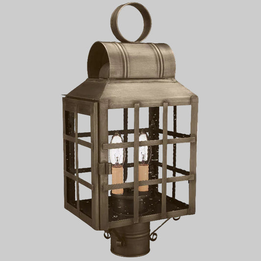 Bronze outdoor lantern with two visible light bulbs on a gray background