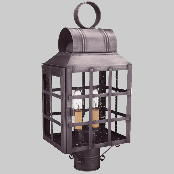 Decorative outdoor lantern with two visible light bulbs on a gray background