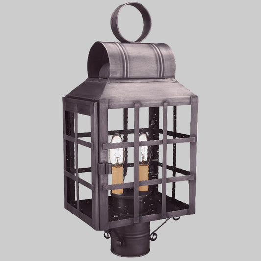 Decorative outdoor lantern with two visible light bulbs on a gray background