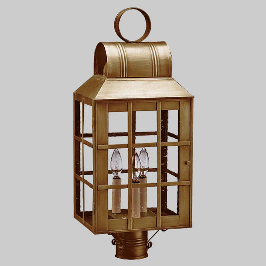 Bronze outdoor lantern with glass panels on a gray background