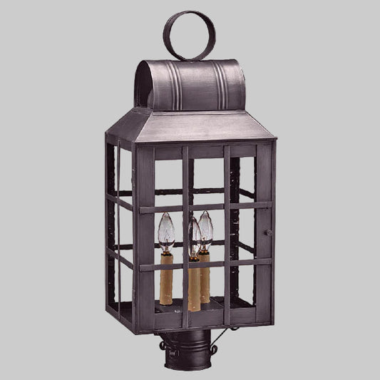 Decorative outdoor lantern with three candle-like lights on a gray background