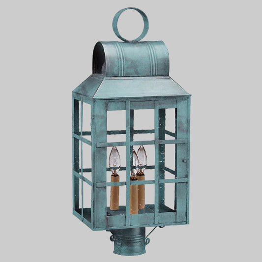 Vintage-style metal lantern with two candle holders on a gray background