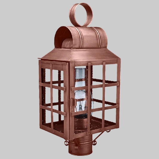 Copper lantern with clear glass on a gray background