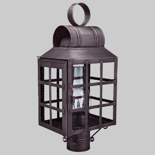 Decorative metal lantern with a clear glass bulb on a gray background