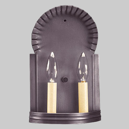 Wall sconce with two candle-style lights on a gray background