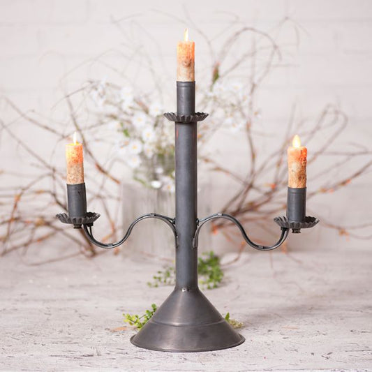 Primitive tin candle holder that accommodates three moving flame bulbs