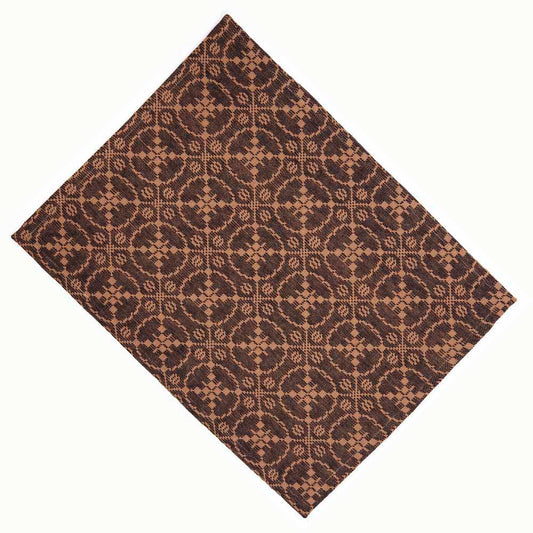 A rectangular jacquard placemat in black with an intricate geometric pattern.
