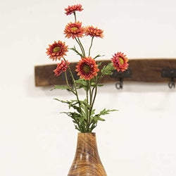 Vase with flowers on a white wall
