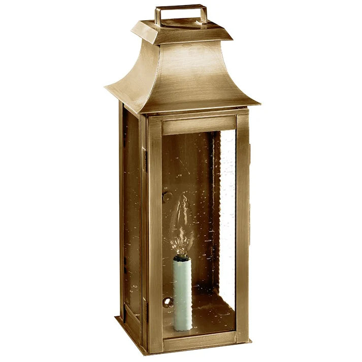 Bronze lantern with a candle inside on a white background