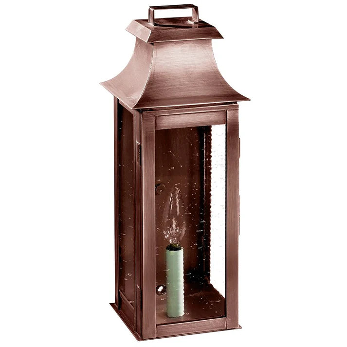 Bronze lantern with a candle inside on a white background