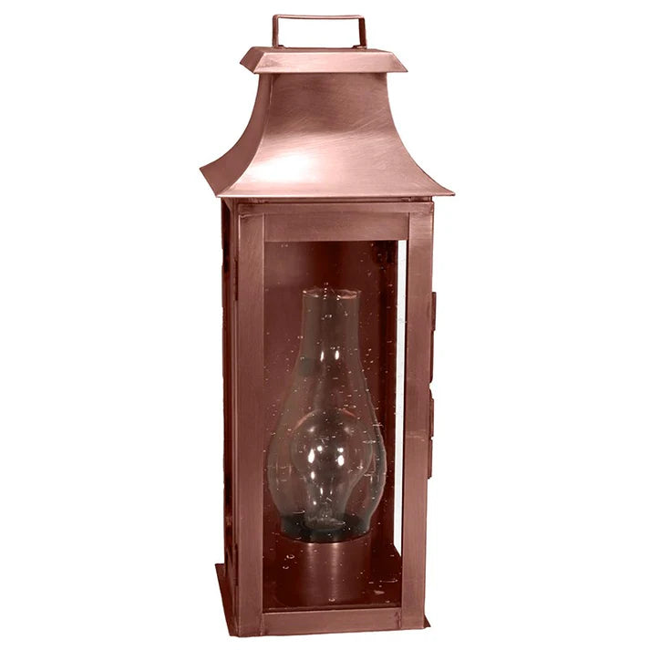Copper lantern with a clear glass shade on a white background