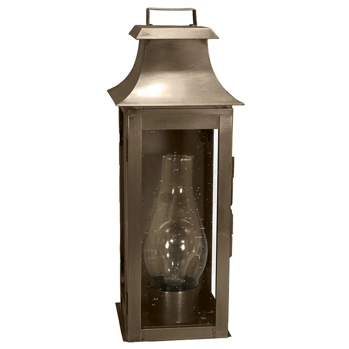 Bronze lantern with a clear glass shade on a white background