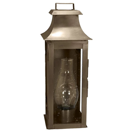 Bronze lantern with a clear glass shade on a white background