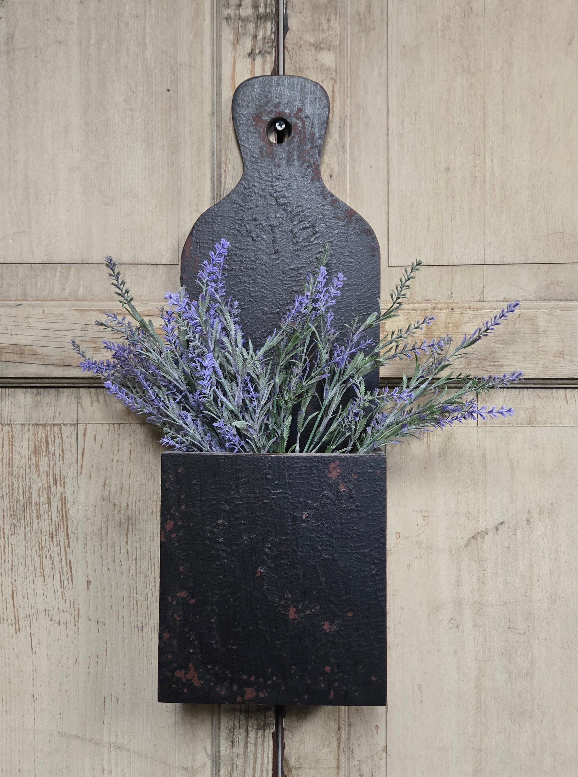 Decorative wall planter with lavender on a wooden background