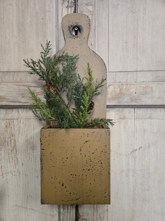 Decorative wall box with greenery on a wooden surface