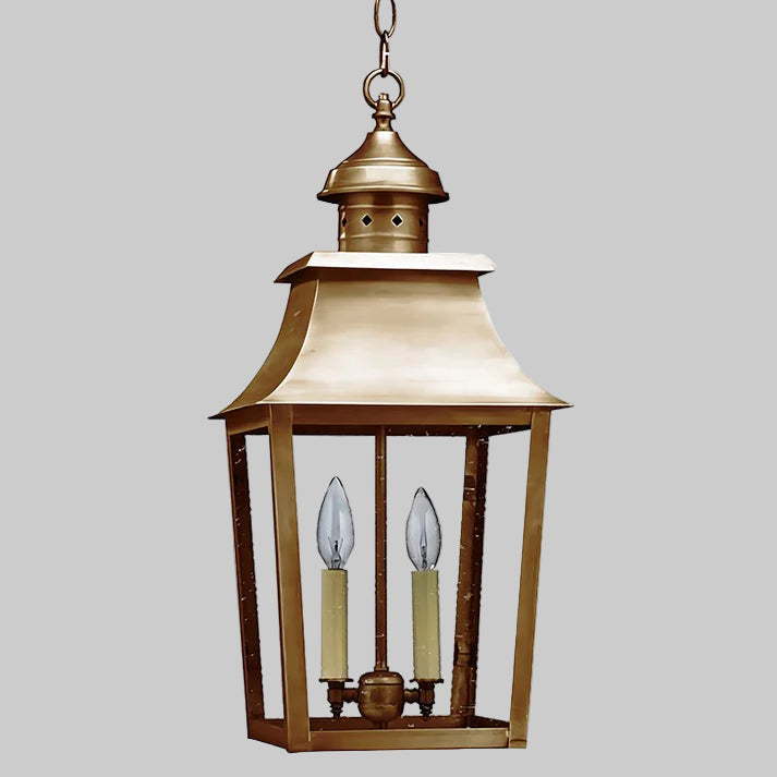 Brass hanging lantern with two candle-like lights on a white background