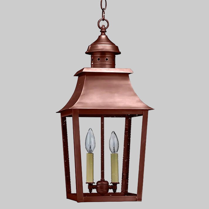 Copper hanging lantern with two candle-like lights on a white background