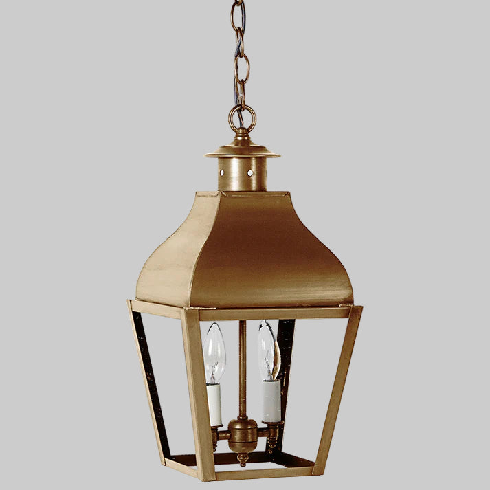 Brass hanging lantern with clear glass on a white background