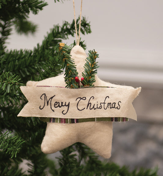 Star ornament with the words Merry Christmas hanging on Christmas tree