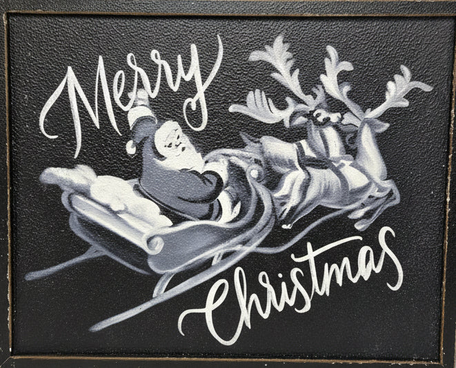 Decorative sign with Santa Claus and reindeer on a black background, text 'Merry Christmas' against a metal panel background.