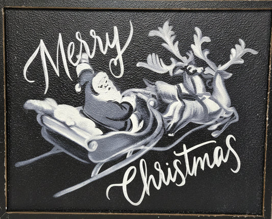 Decorative sign with Santa Claus and reindeer on a black background, text 'Merry Christmas' against a metal panel background.