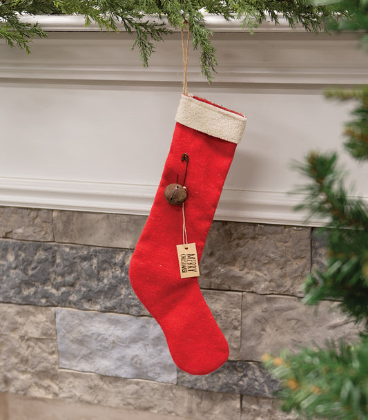 Merry Christmas red stocking ornament hanging from mantle with greenery