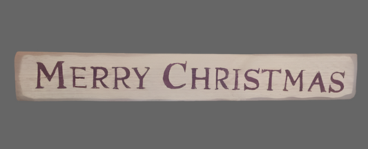 A wooden sign with the phrase 'Merry Christmas' carved on it, against a grey background.