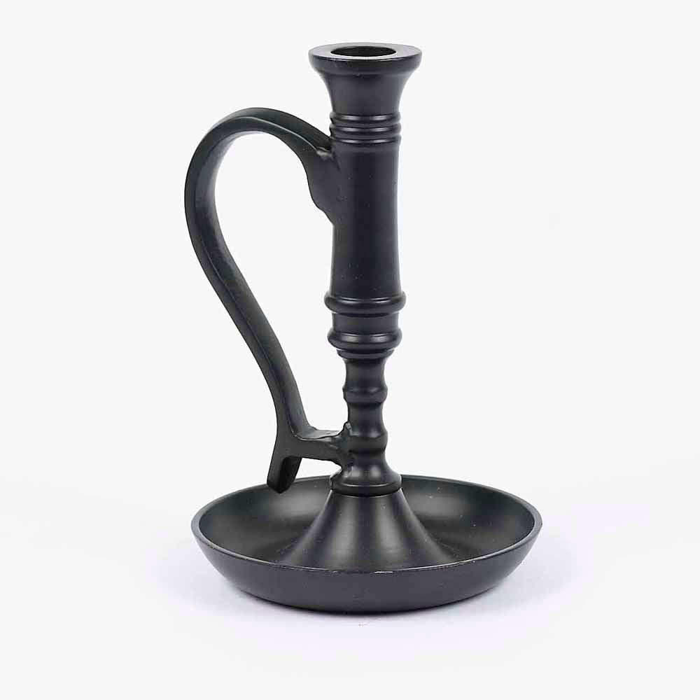 A black metal candle holder with a classic design, featuring a cup-shaped base and a tapering holder with a loop on top for easy lighting.