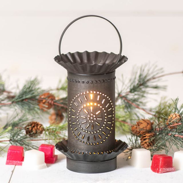 Decorative lantern with a chisel design on a white background with pine branches and candles.
