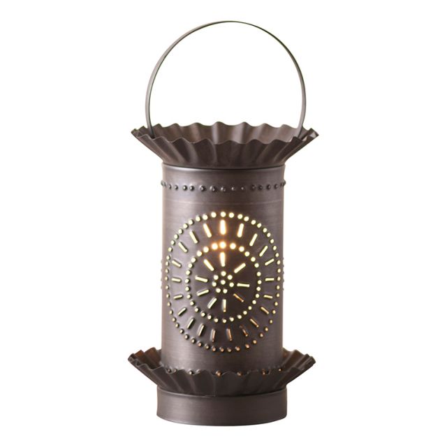 A black mini tartwarmer with chisel design in a kettle shape, featuring a lit wick in the center and a handle at the top.